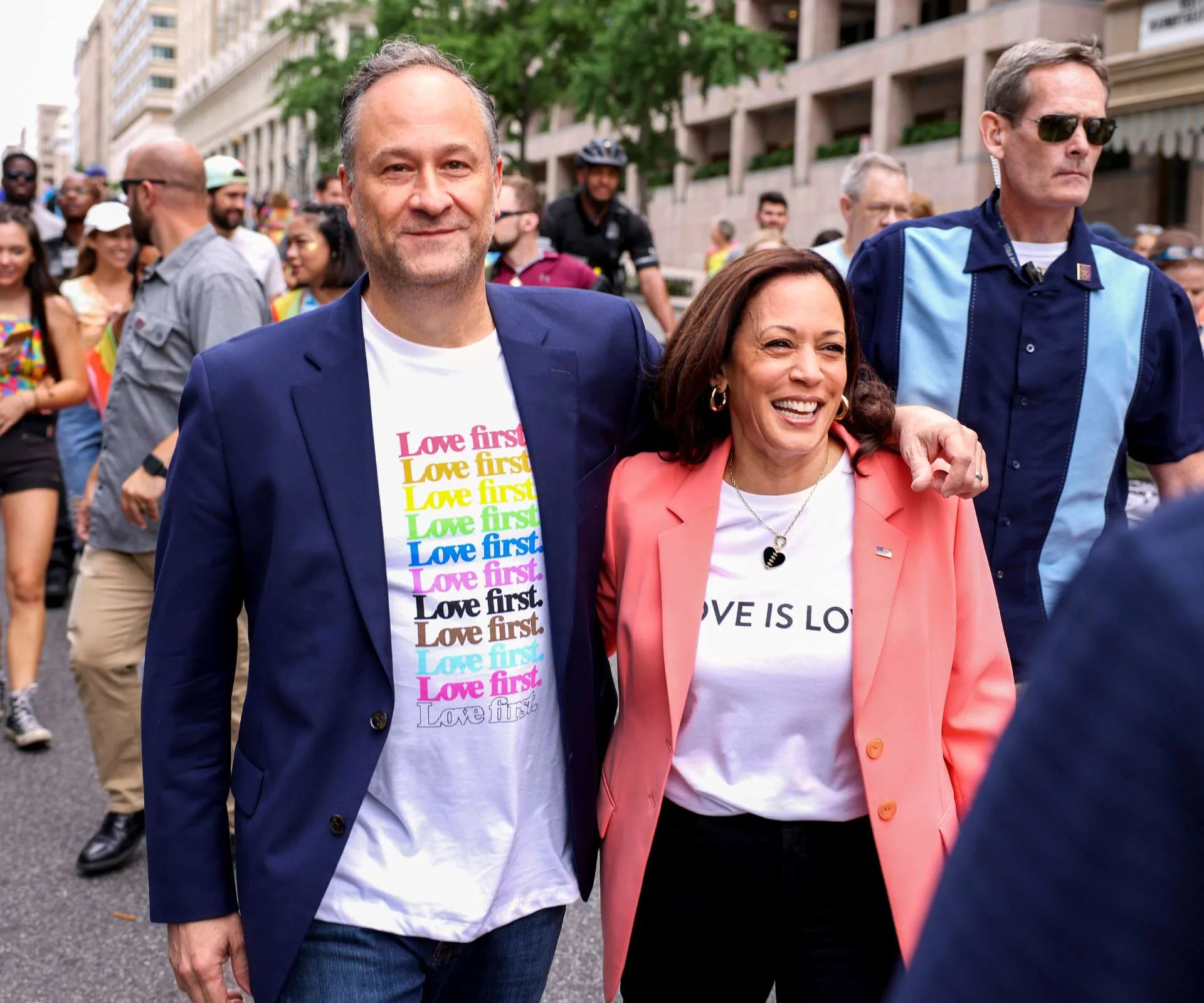 Kamala Harris walking in a campaign with her husband's arm over her shoulder