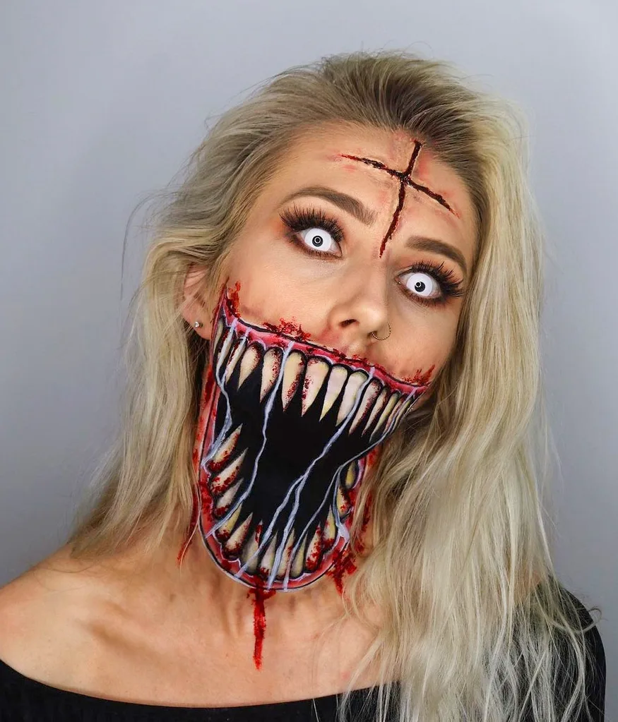 Alyshia wearing white contact lenses and makeup of overdrawn jaw and teeth down her face and neck