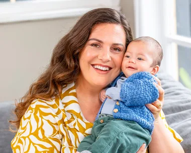 K'lee holding baby Micah up to her face and smiling