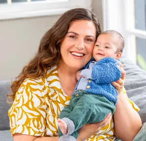 K'lee holding baby Micah up to her face and smiling