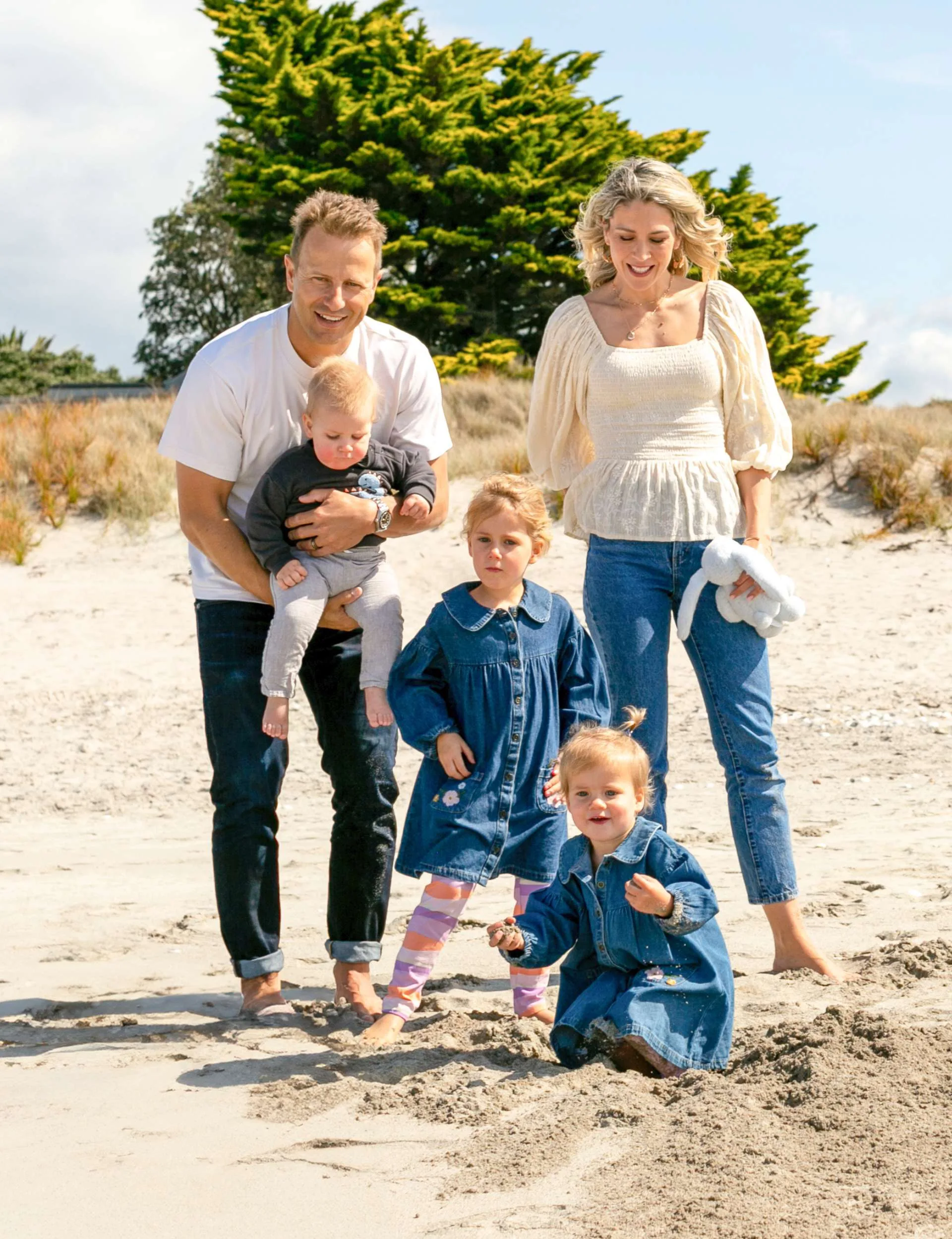 Neil Wagner on a beach with his wife and kids