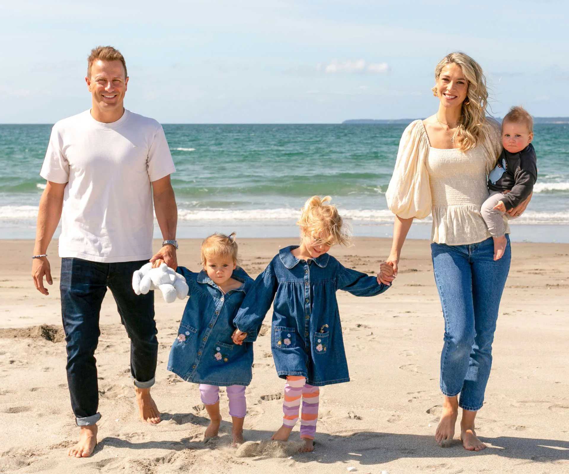 Neil Wagner on a beach with his wife and kids