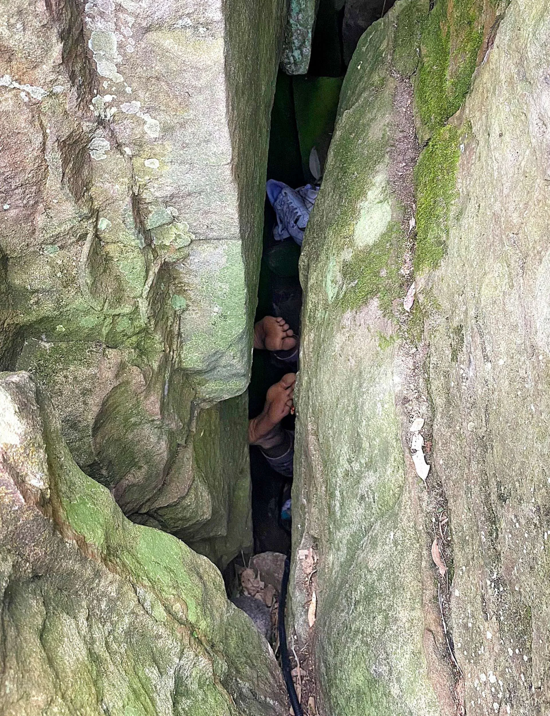 Matilda Campbell's feet stuck between the boulders