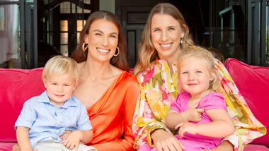 Brooke and Lucy sitting with their kids on their laps