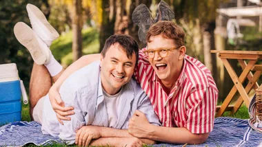 Tom and Chris laying on a picnic blanket together