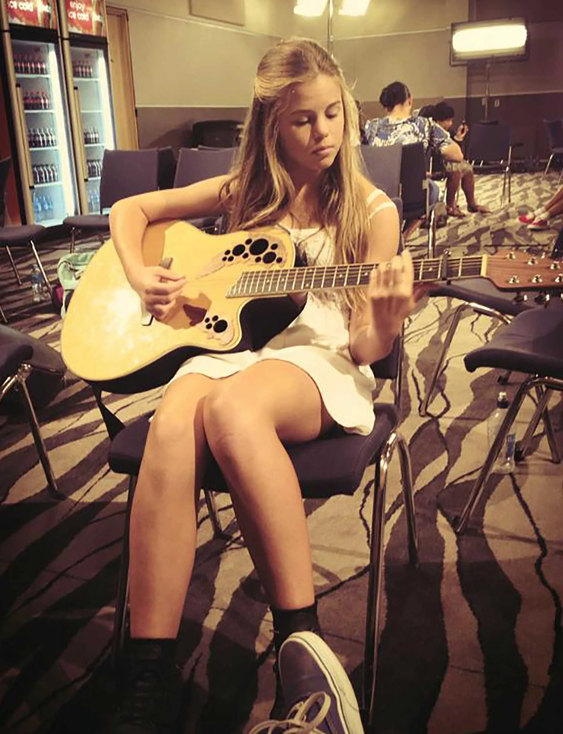 Cassie Henderson practicing the guitar when she was younger