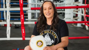 Daniella Smith sitting on the side of a boxing ring