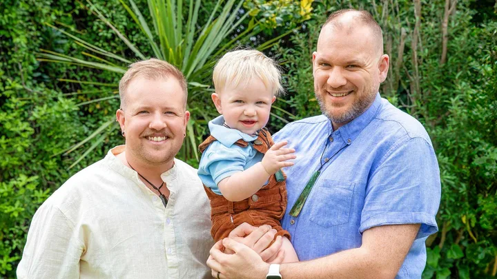 Frankie and Rawa holding their son