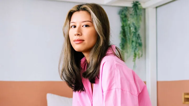 A woman looking at the camera experiencing burnout