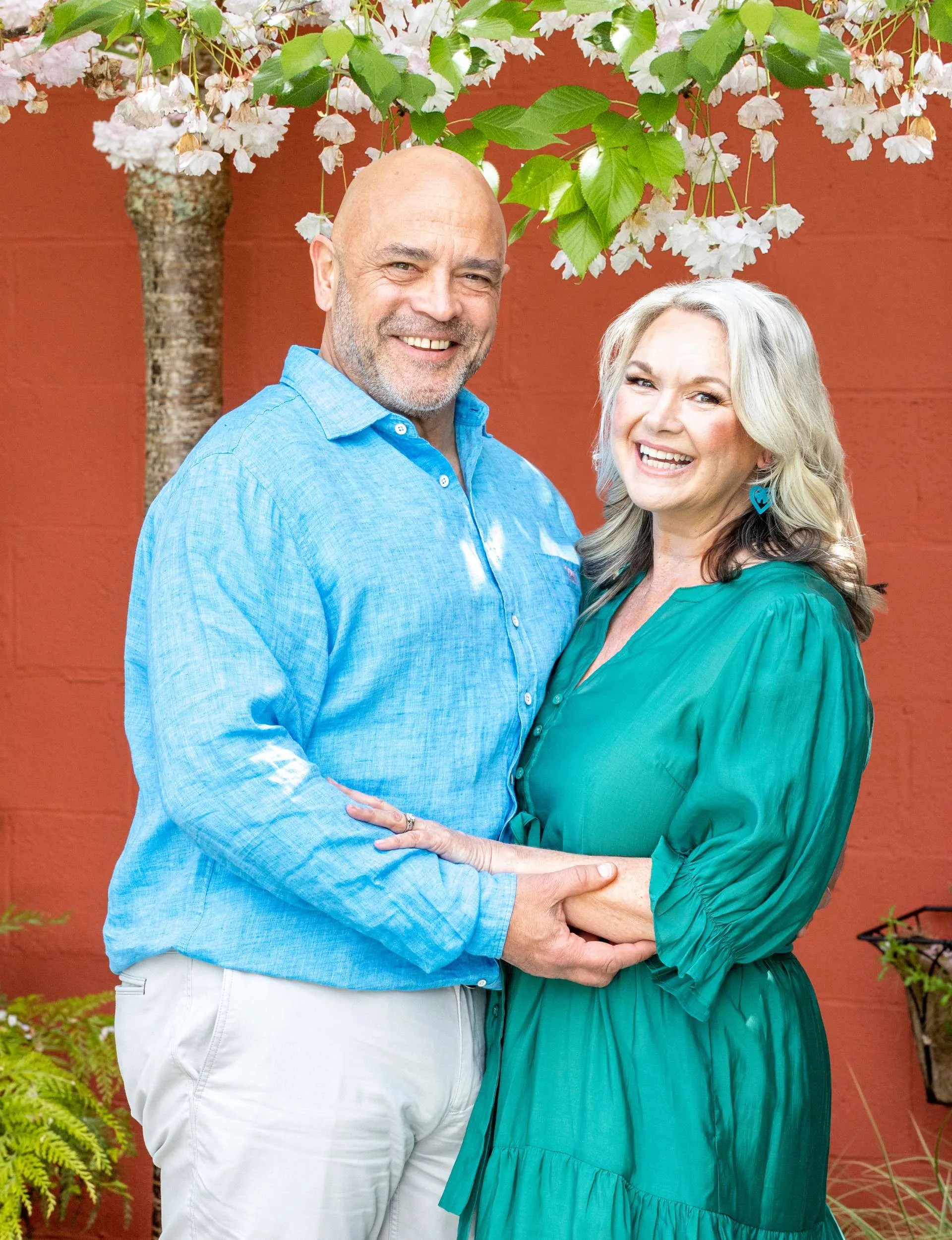 Grant Kereama holding his new wife Lisa under a blossom tree
