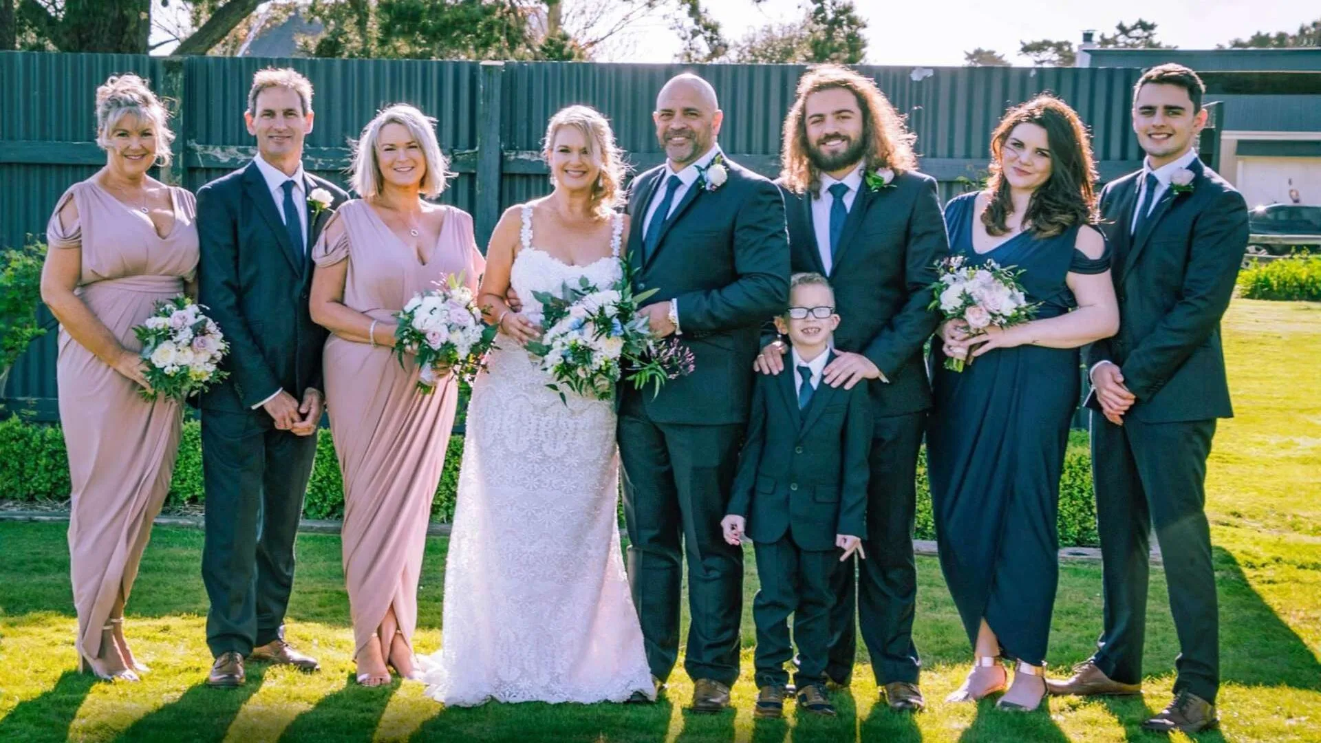 Grant with wife Lisa and their family on their wedding day