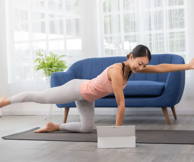 A woman doing the Bird Dog pose