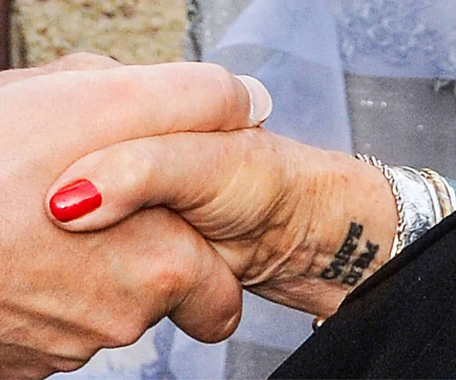 Dame Judi's 'Carpe Diem' wrist tattoo