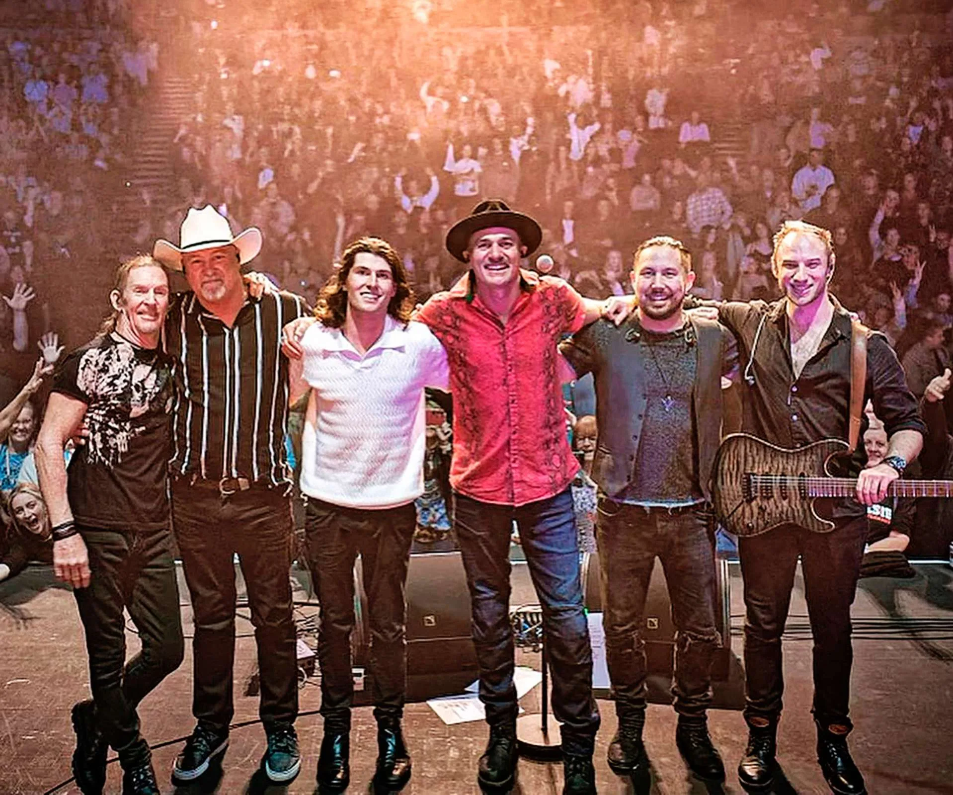 Shannon Noll on stage with his son and their band