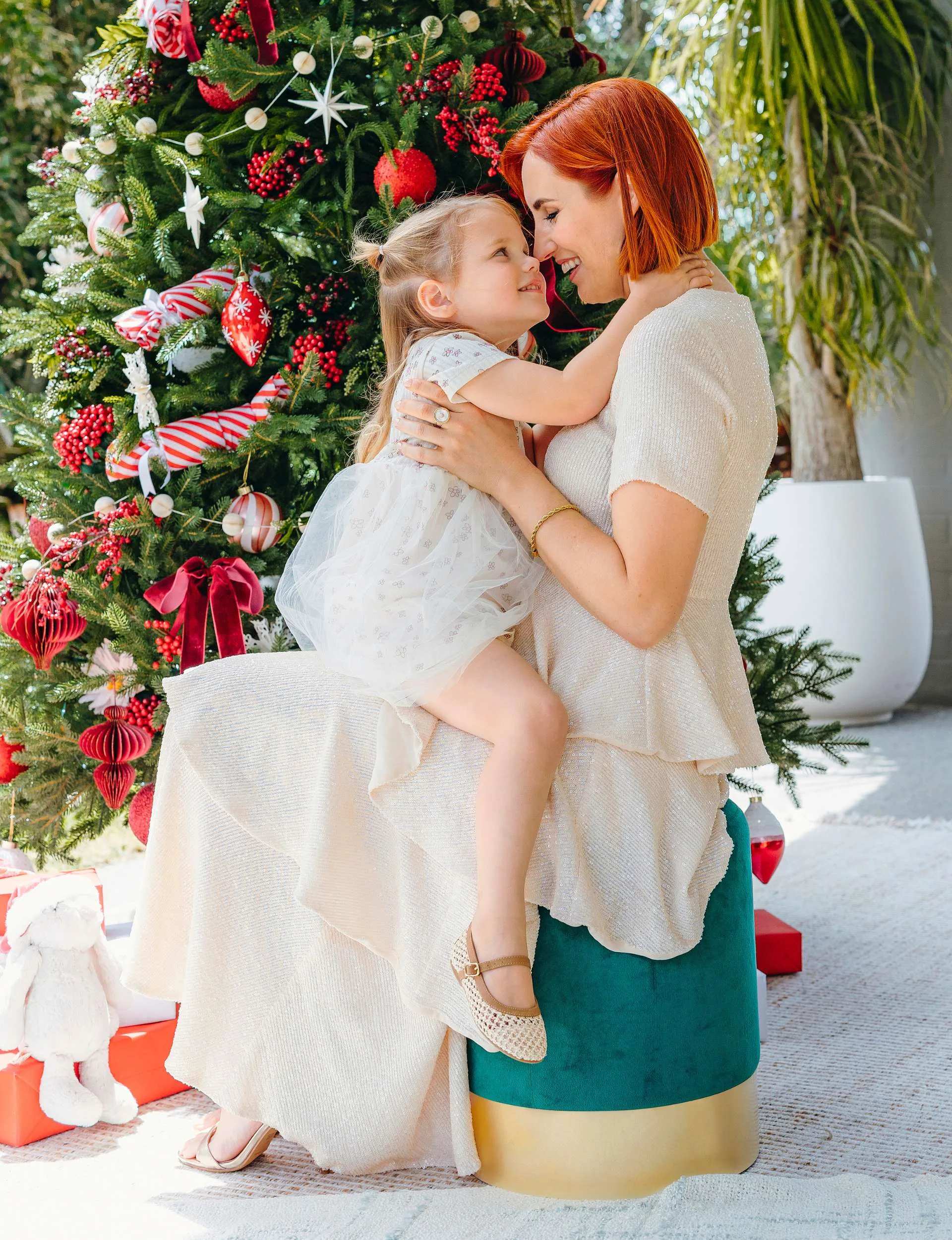 Samantha and Amaya playing in front of the Christmas tree