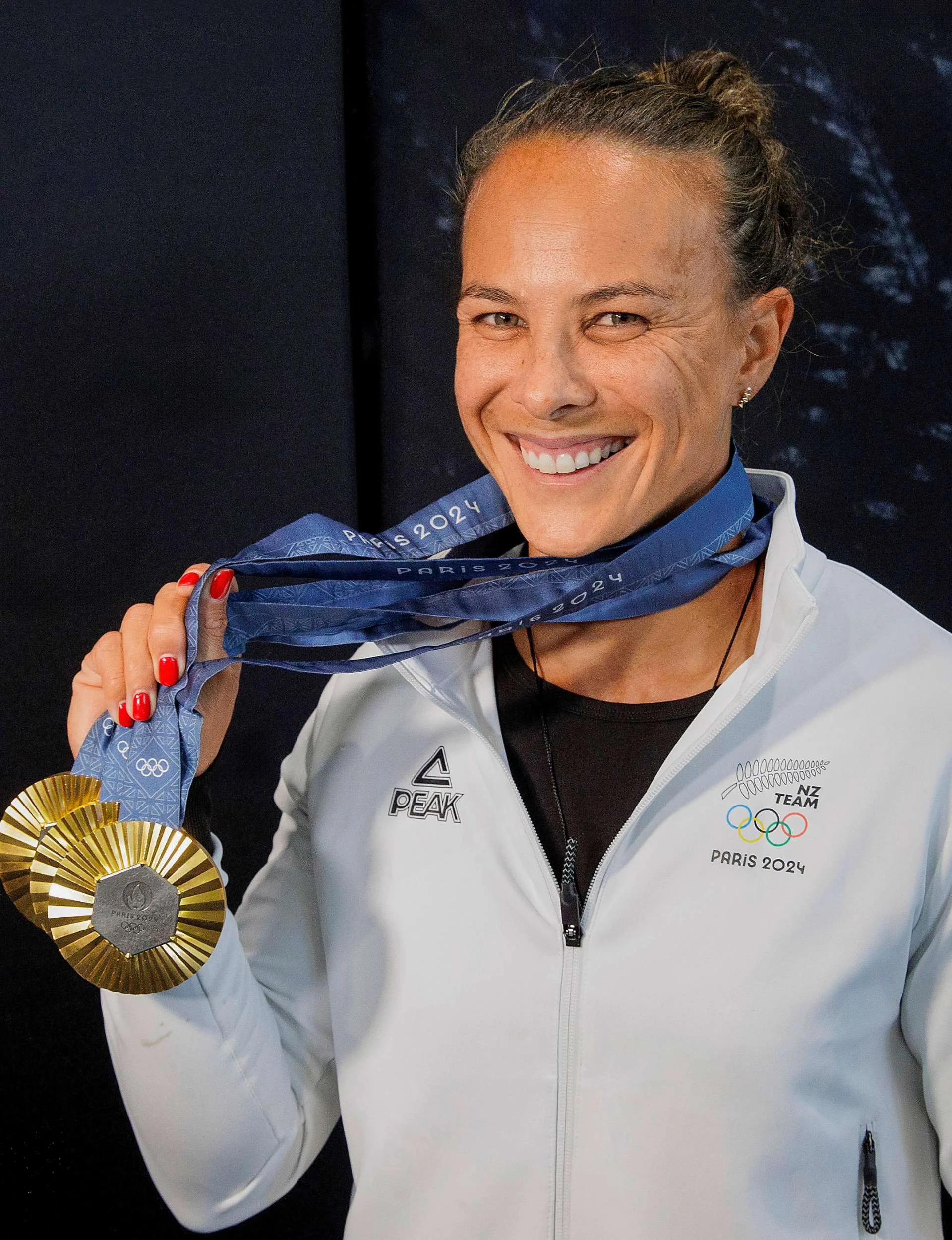 Dame Lisa Carrington with her gold medals