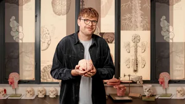 Guy Williams holding a fake brain