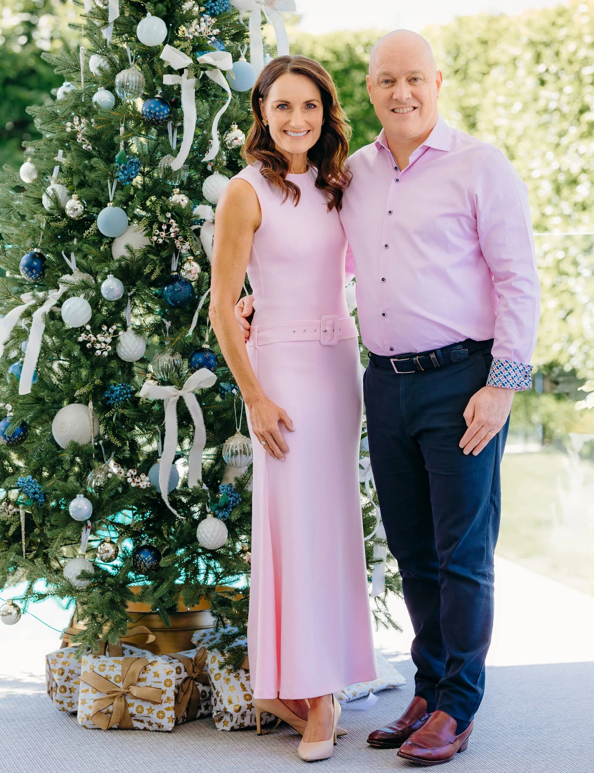 Christopher Luxon with his wife Amanda standing in front of their Christmas tree