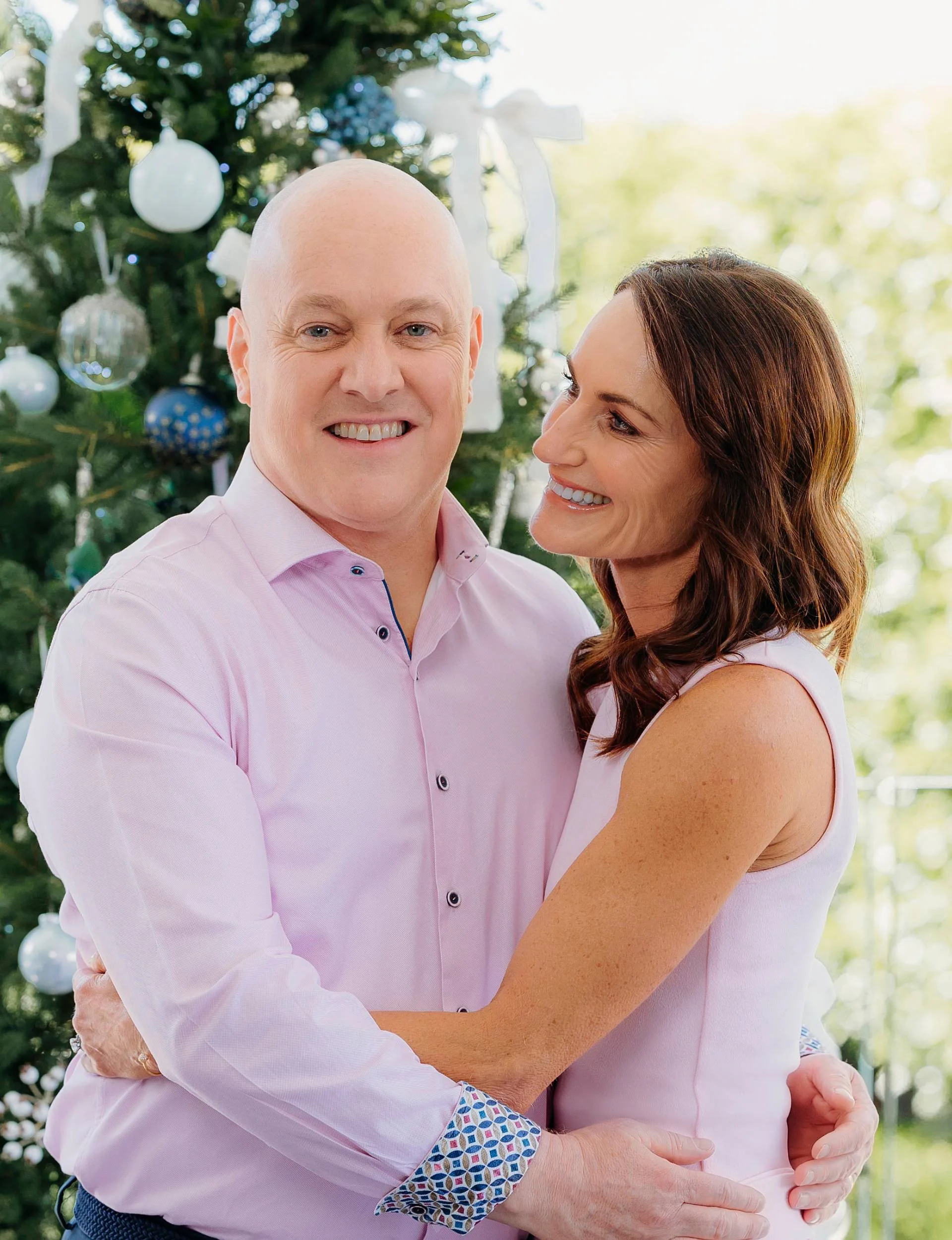 Christopher Luxon hugging his wife Amanda in front of their Christmas tree