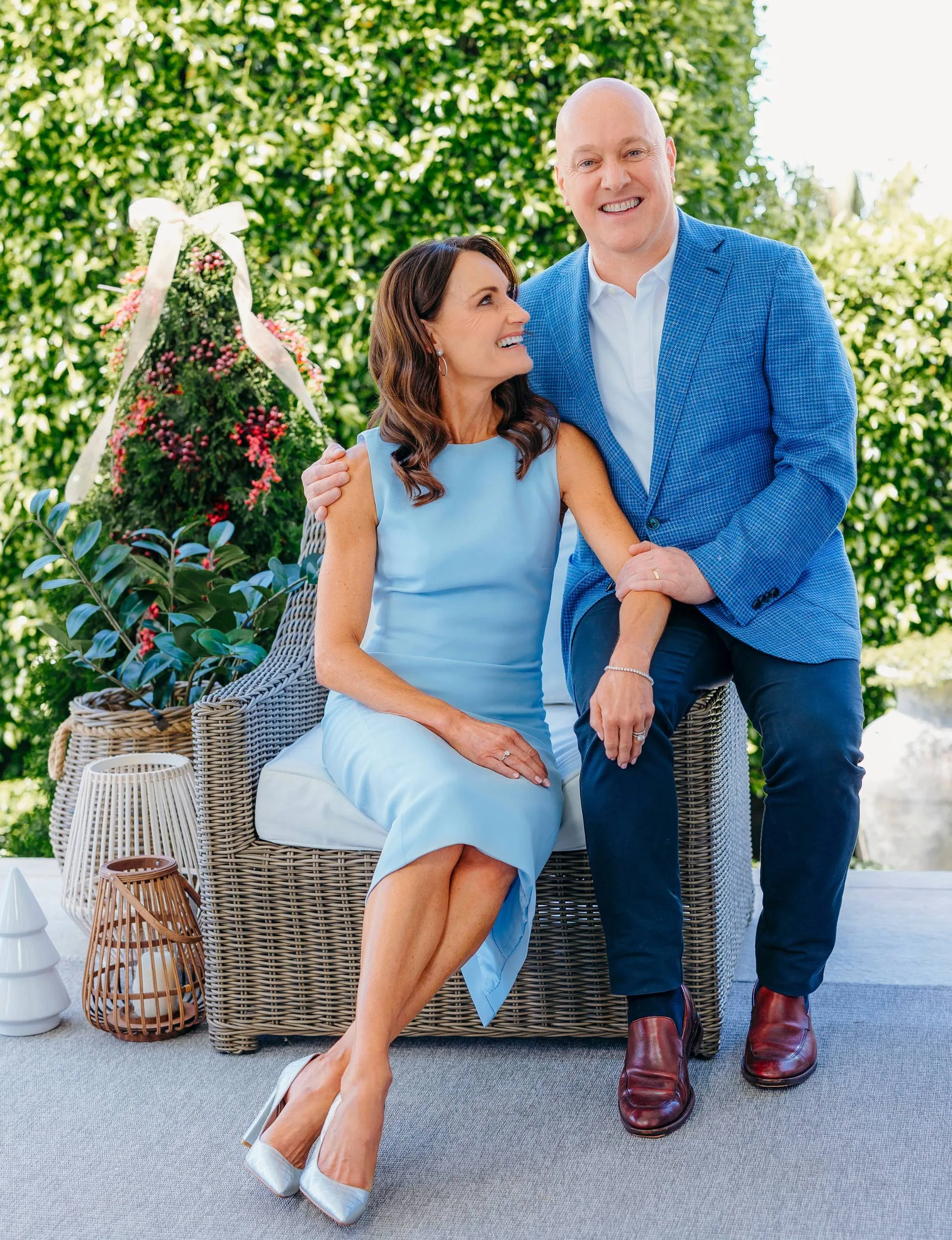 Christopher Luxon with his wife Amanda sitting in front of their Christmas tree