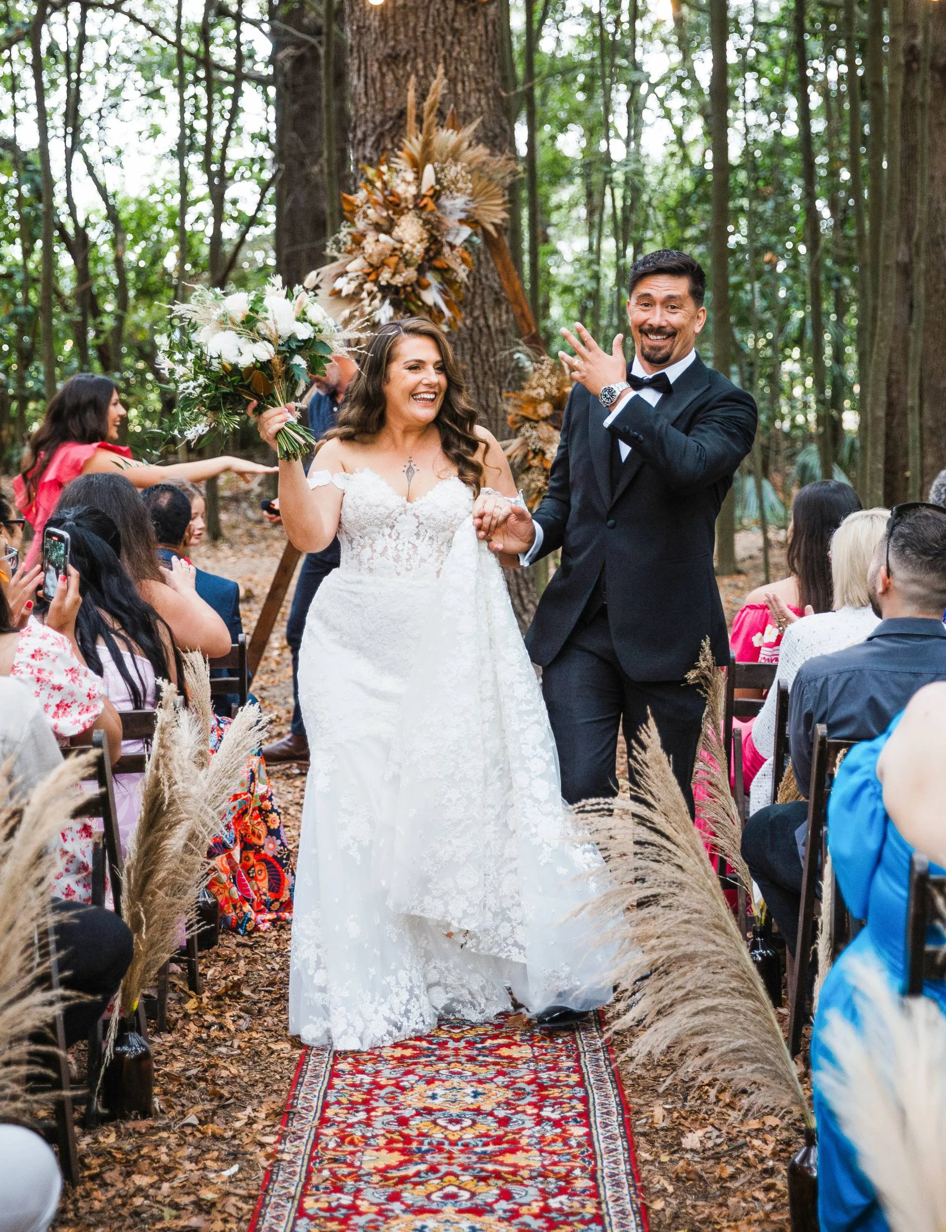 K’Lee and husband Lama Saga walking down the aisle out of their ceremony