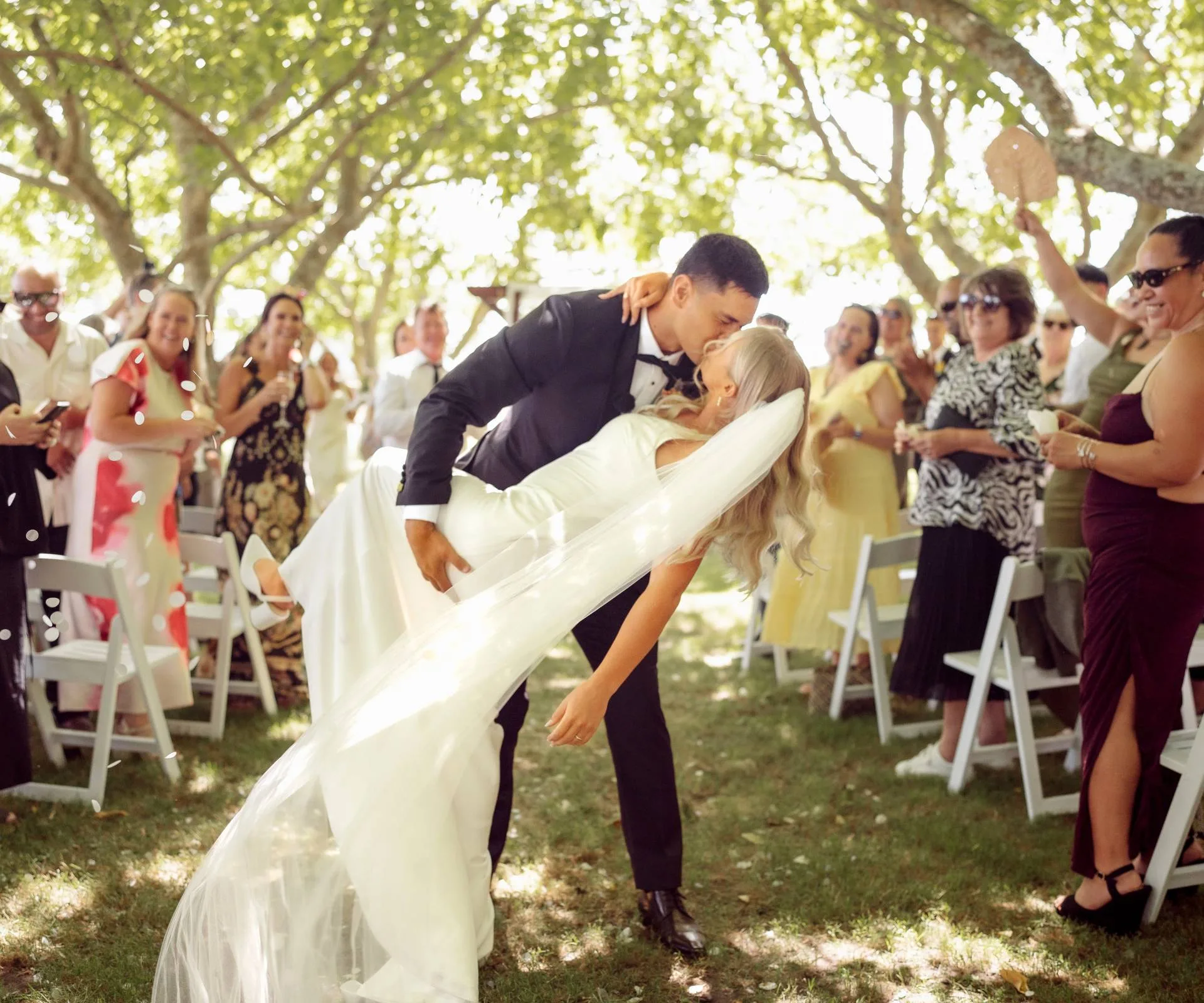 Grace Steinmetz and Rameka Poihipi kissing at the end of the aisle