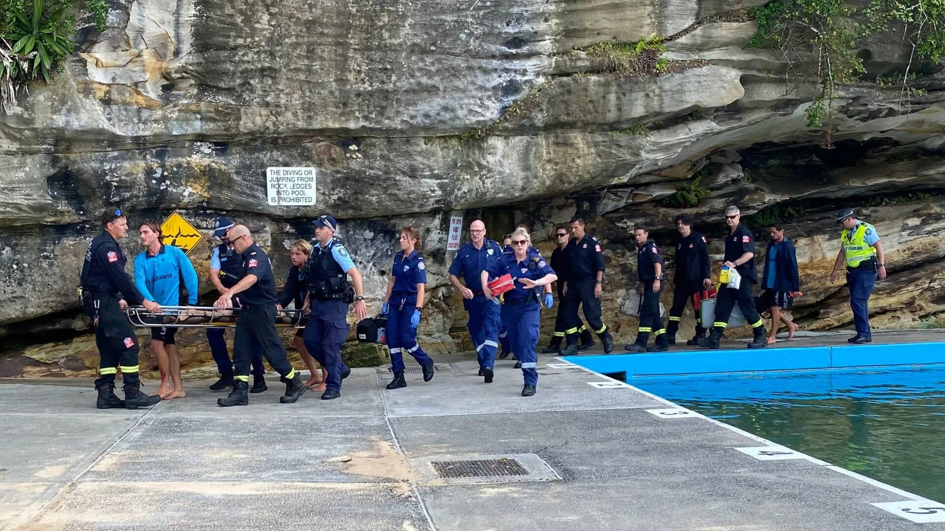 Paramedics carring Artaban de Lacharriere out on a stretcher