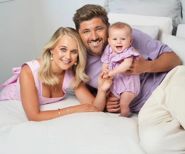 Couple and baby wearing purple