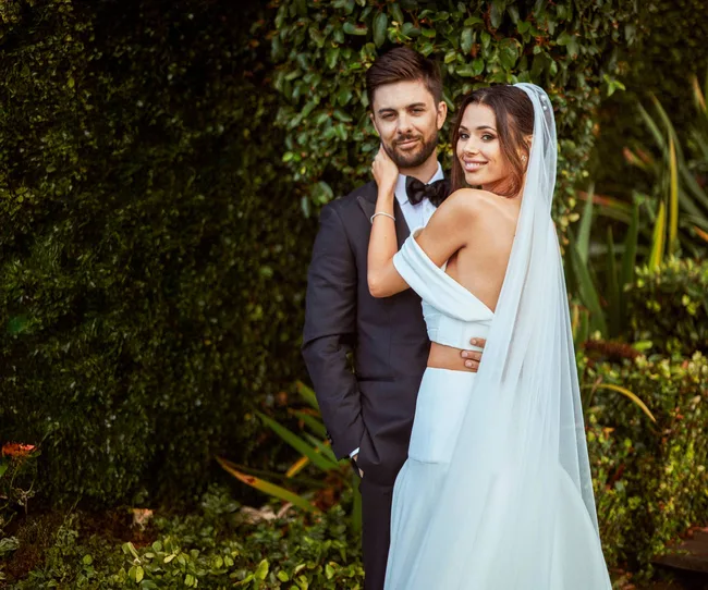 Wedded couple in front of bush