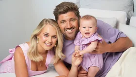 Woman's Day photograph of Rebekah Randell, her husband and their baby who was born in 2024