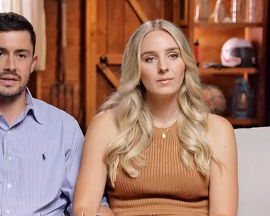 Jesse and Paige sitting on a couch talking to the camera