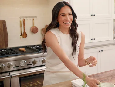 Meghan smiling in her kitchen on her series, With Love, Meghan