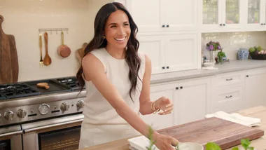 Meghan smiling in her kitchen on her series, With Love, Meghan