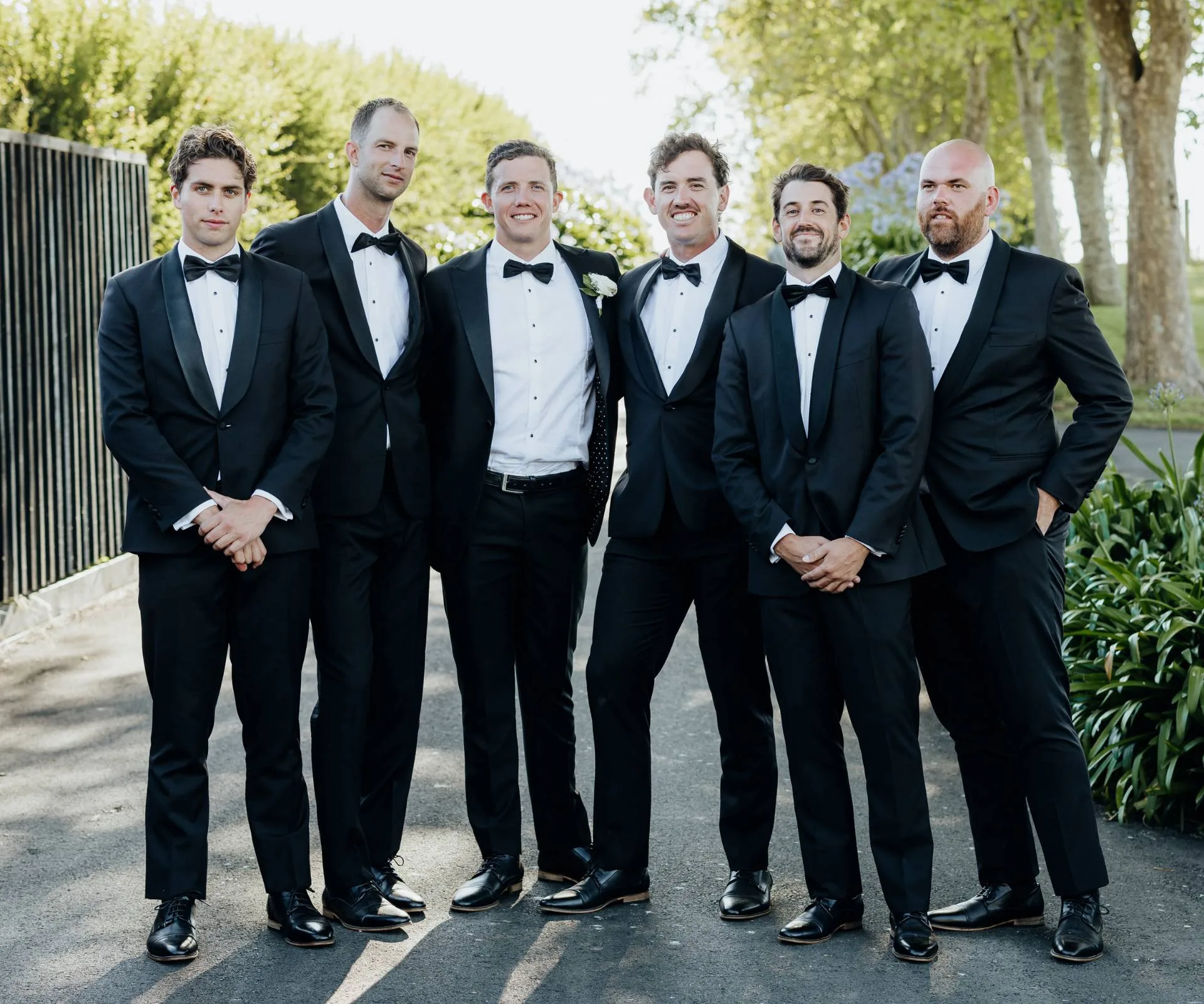 Michael with his groomsmen in black suits