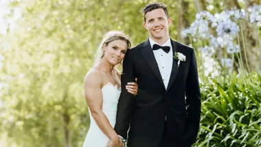 Michaela Blyde holding her new husband's hand on their wedding day