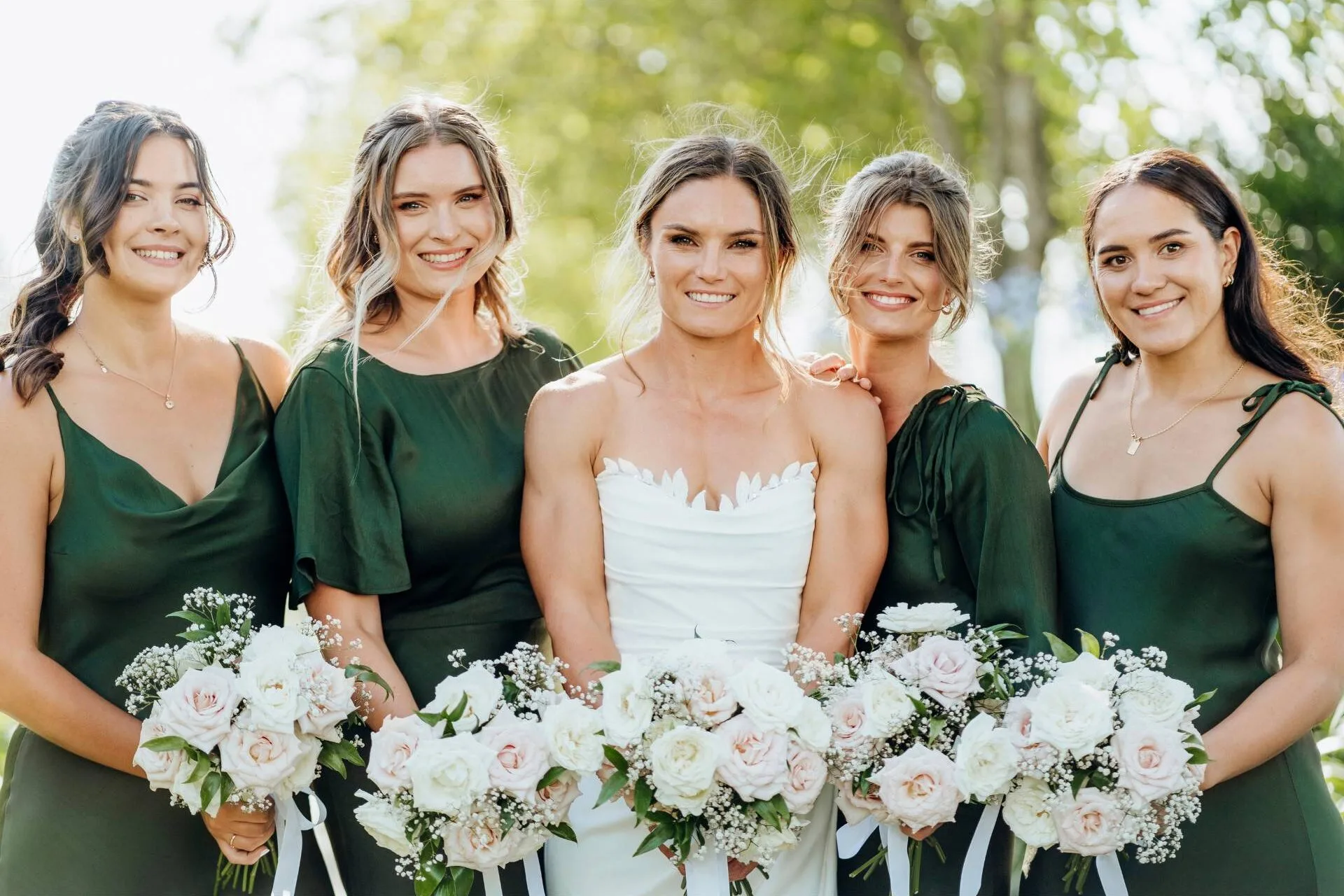 Michaela with her bridesmaids in olive green dresses