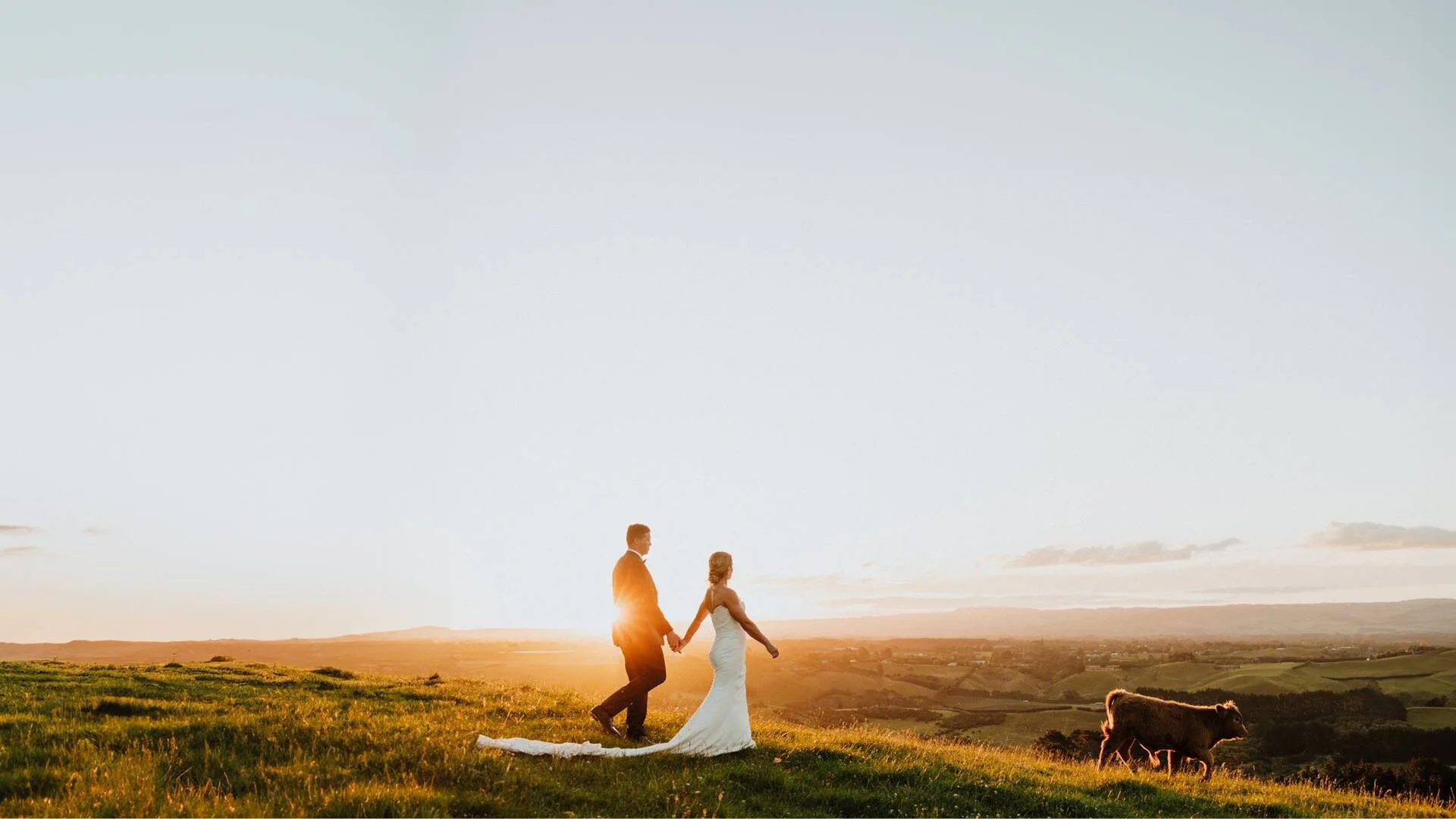 Michaela and Michael walking along a ridgeline on sunset