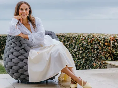 Dame Lisa Carrington sitting on an outdoor armchair