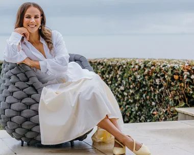 Dame Lisa Carrington sitting on an outdoor armchair