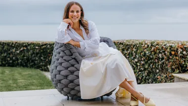 Dame Lisa Carrington sitting on an outdoor armchair