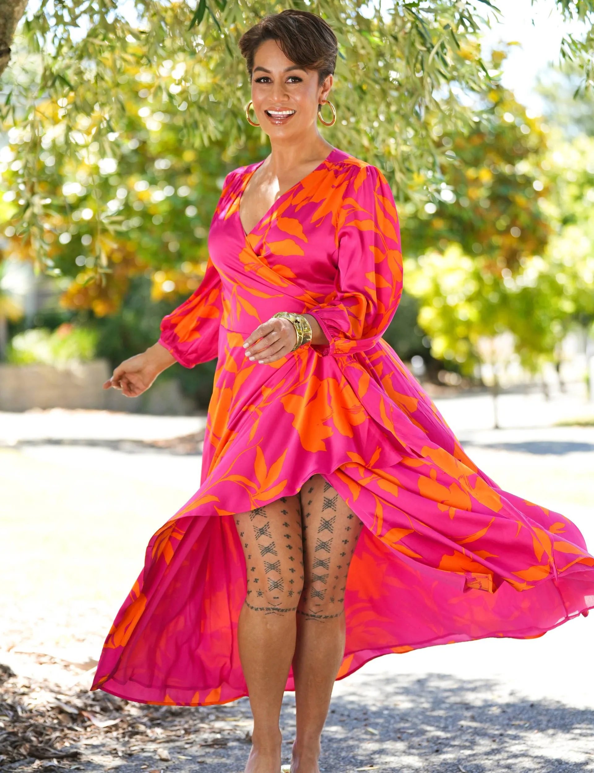 Teuila dancing in a red and orange dress