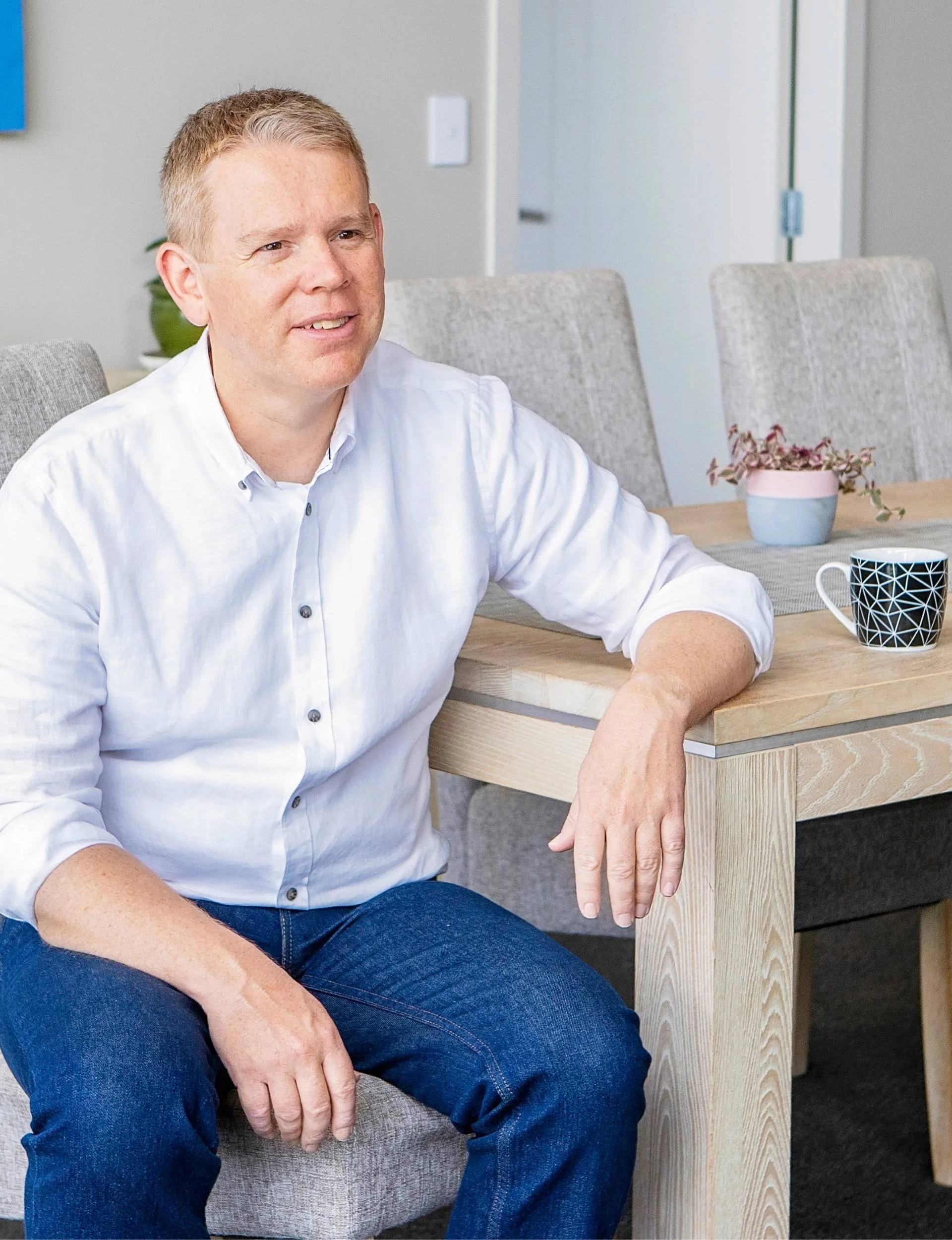 Chris sitting at a light wooden table