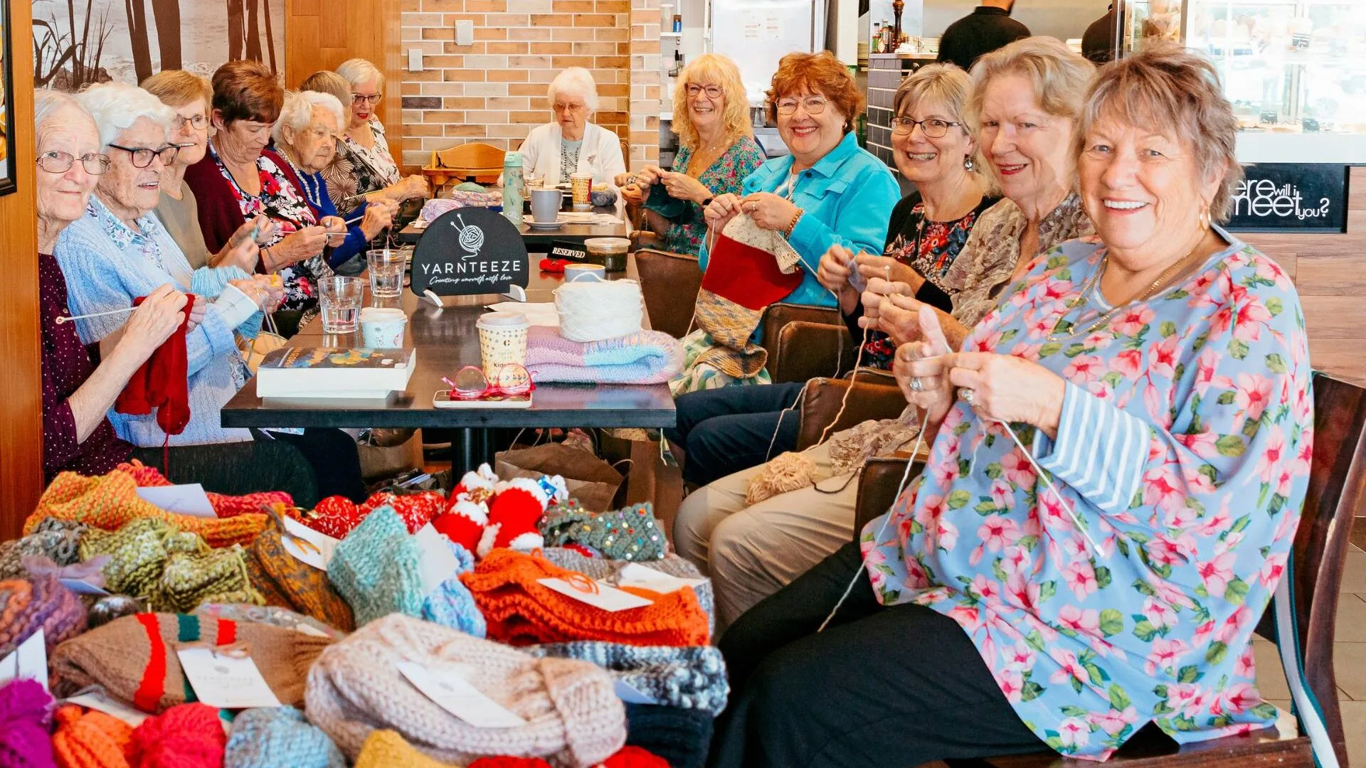 Trish Stewart crafting in a café with the Yarnteeze