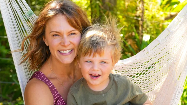 Ria Vandervis sitting on a hammock with her son, Teddy