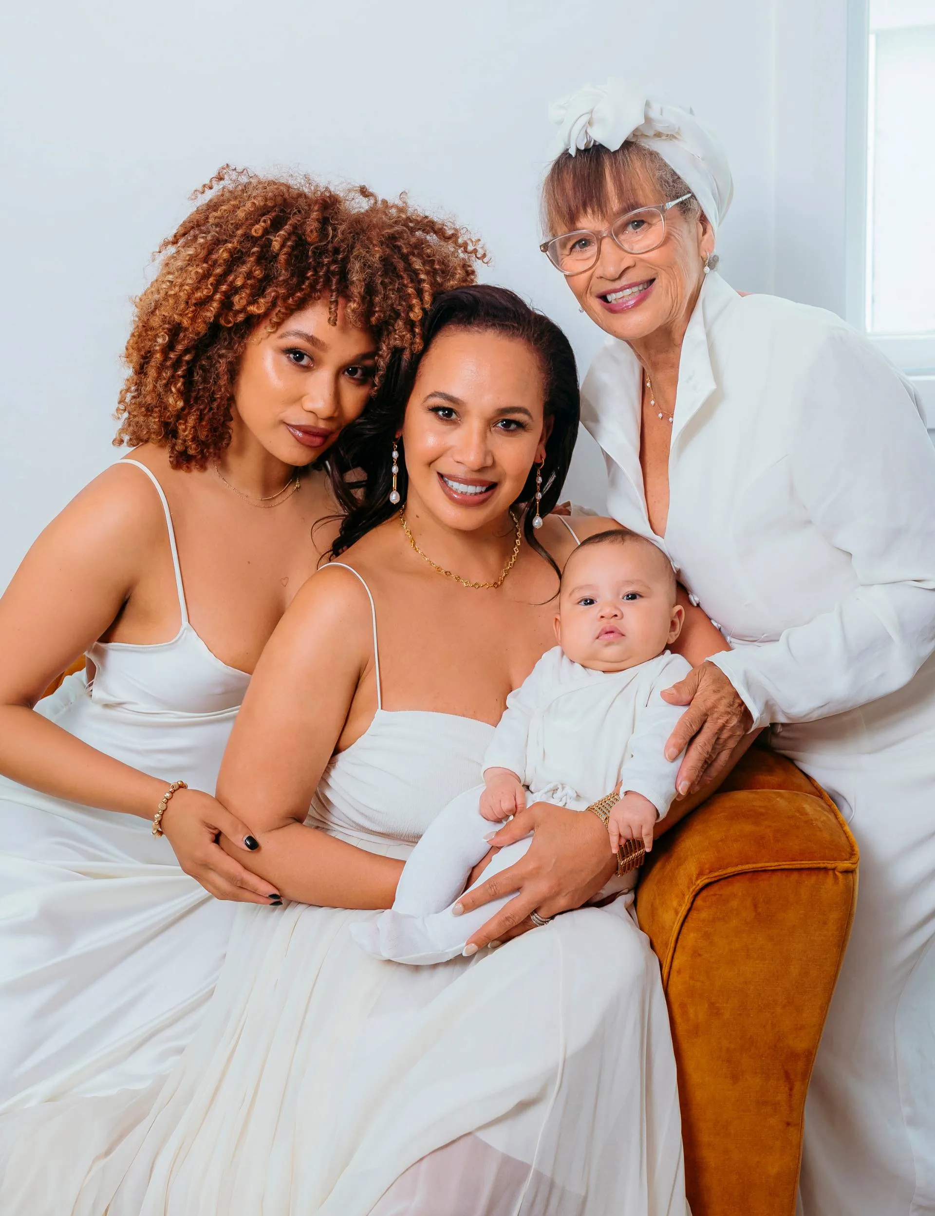 Megan Alatini with her mum, daughter and granddaughter on a couch