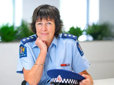 Female cop sitting at desk