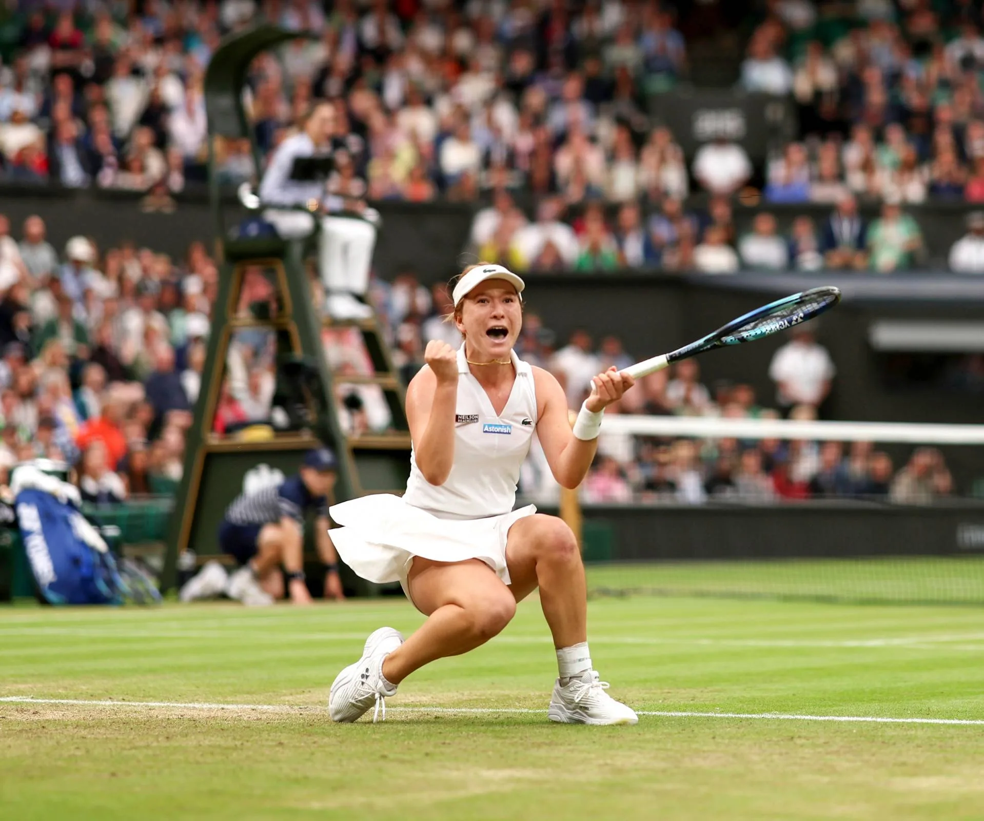 Woman winning a score in tennis and celebrating