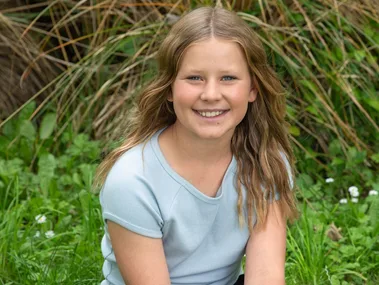 Sarah Wadsworth sitting on some grass