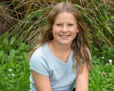 Sarah Wadsworth sitting on some grass