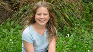 Sarah Wadsworth sitting on some grass